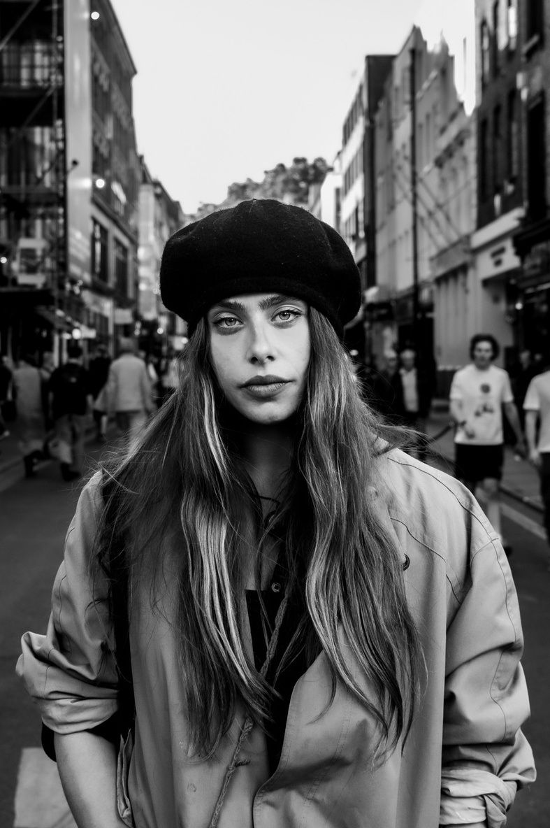 Black and white portrait of Kim Mac in a beret on a street in Soho.